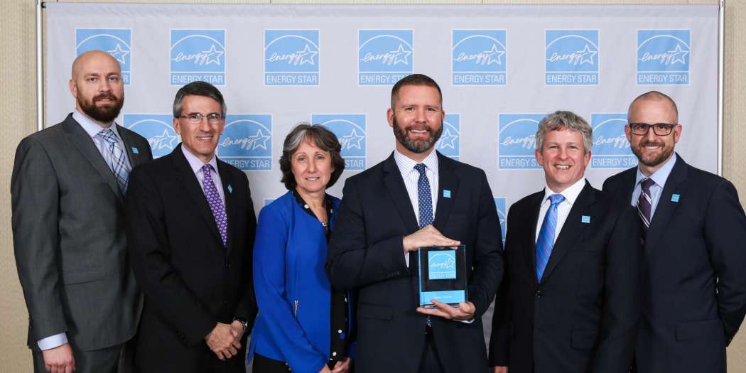 Bozzuto representatives accepting 2022 Corporate Impact Award by So Others Might Eat (SOME).