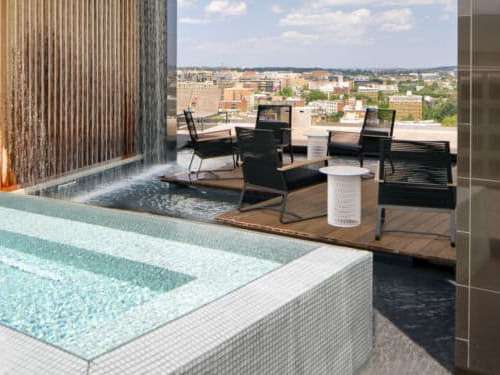 An alluring reflecting pool and a cascading custom waterfall add radiance and motion to the rooftop experience.