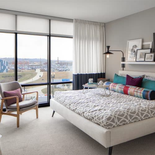 Light filled bedrooms with floor-to-ceiling glass windows offering gorgeous waterfront views.