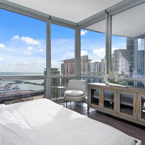 Sun streaming through the window into a spacious master bedroom.