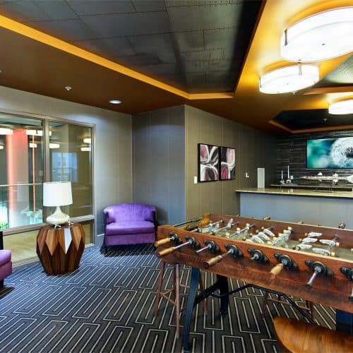 Phenomenal game room with poker table, billiards, pub-style shuffleboard and bar area.