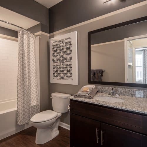 Granite counterops and subway tile backsplash in each bath.