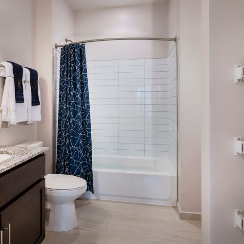 Each bathroom features subway tile backsplash and rich cabinetry.