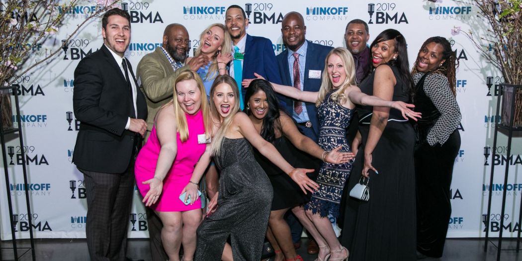 Bozzuto's diverse group of individuals smiling and posing for a photo at a social event.