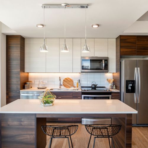 The Witmer : Darkwood cabinets and white granite on stainless steel