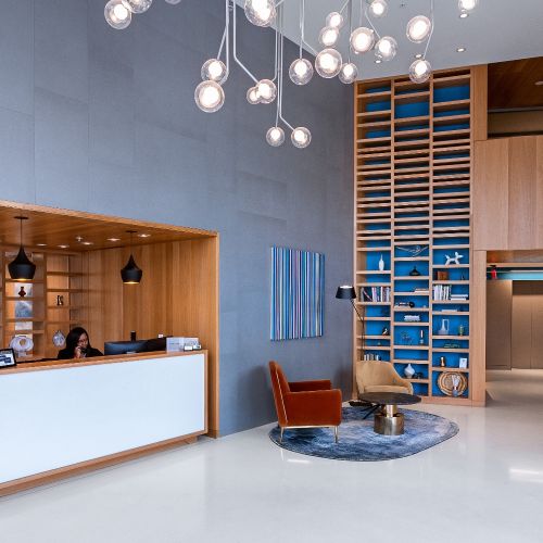 A cascading waterfall and modern, open lobby welcome you home