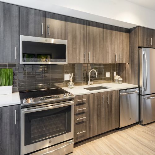 Modern, bright kitchens featuring stainless steel appliances.