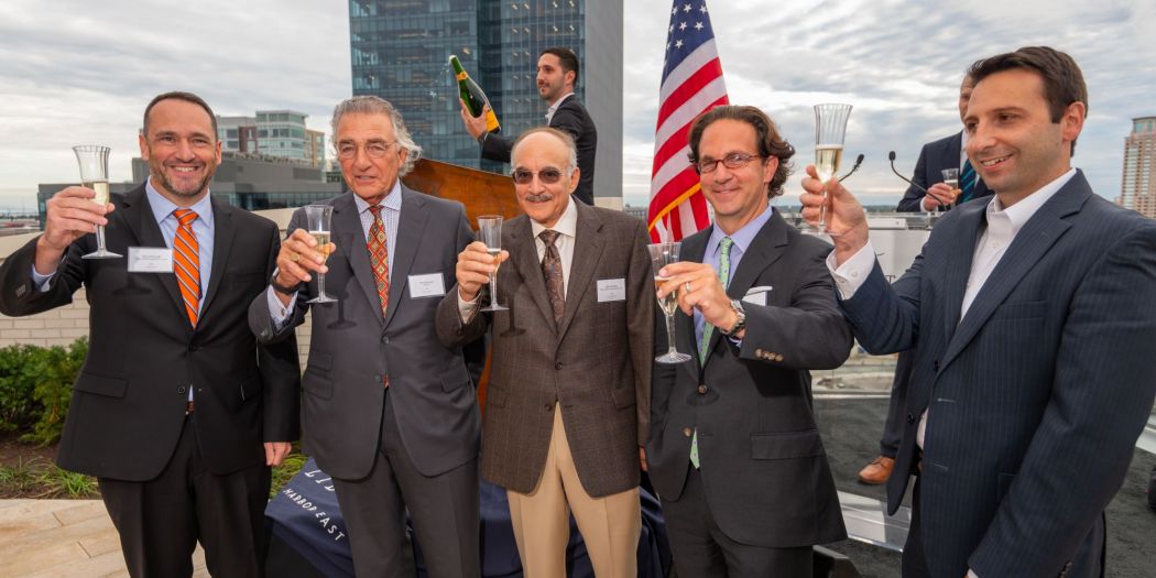 Reps from Bozzuto and Harbor East Management Group celebrating a toast.
