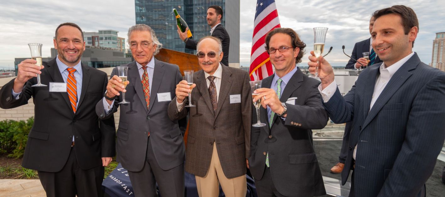 Reps from Bozzuto and Harbor East Management Group celebrating a toast.