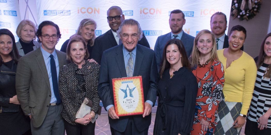 Chairman Thomas Bozzuto holding the 2019 Icon Honors award and posing with Bozzuto Group professionals.