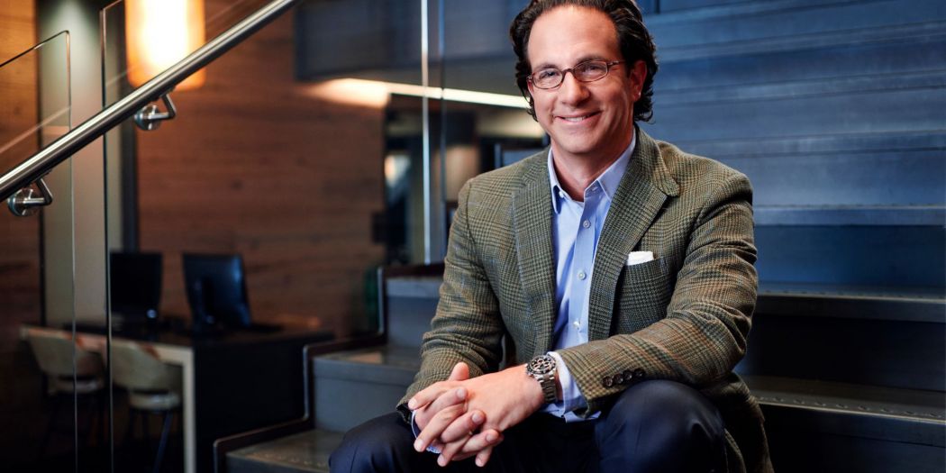 Toby Bozzuto, Bozzuto Group President and CEO, sitting on a stairway.