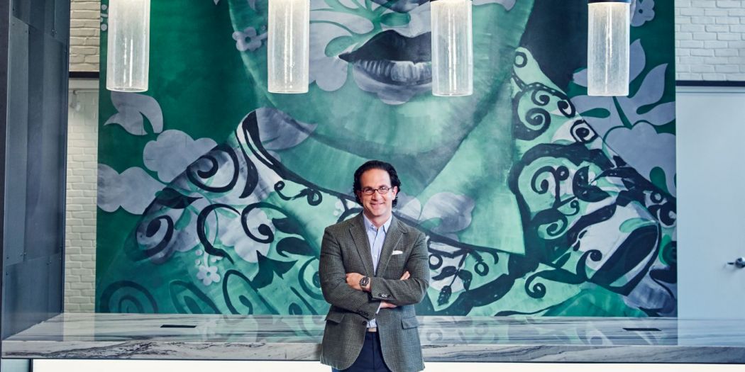 Toby Bozzuto, Bozzuto Group President and CEO, posing in front of a mural.