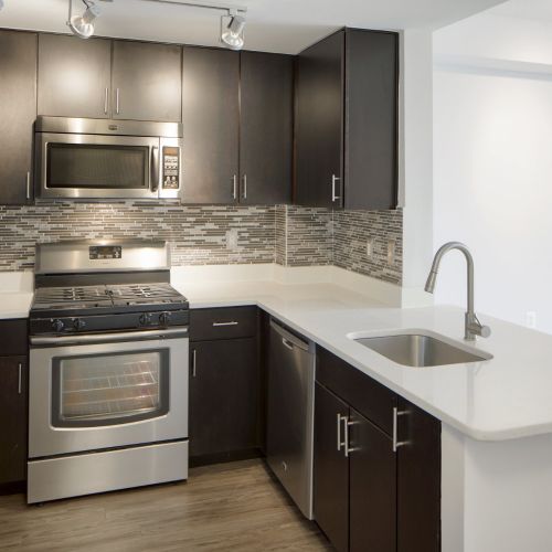 White quartz counters and dark espresso cabinets create an elegant juxtaposition 