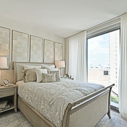 Bedrooms flushed with light from dramatic floor-to-ceiling windows.