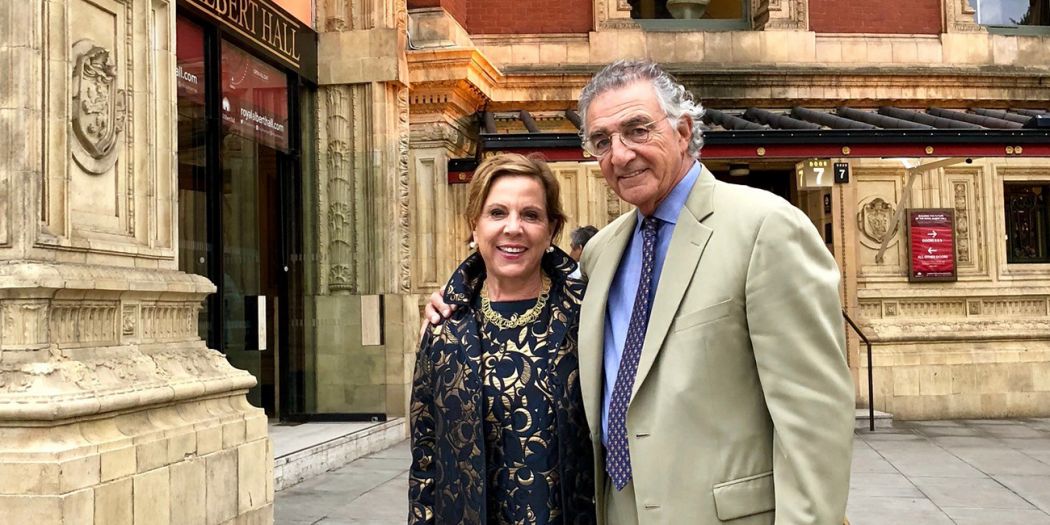 Barbara and Thomas Bozzuto posing in front of a classically designed building.