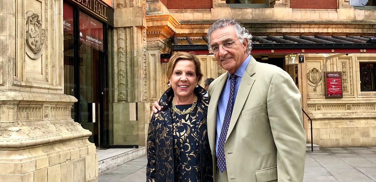 Barbara and Thomas Bozzuto posing in front of a classically designed building.