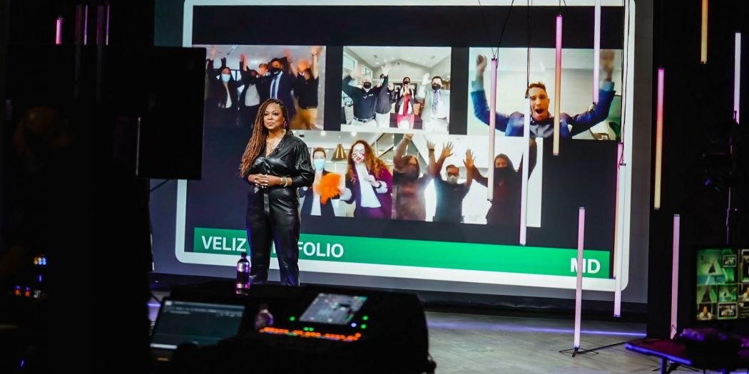 Stephanie Williams, Bozzuto Management Co. President, standing on a large screen.