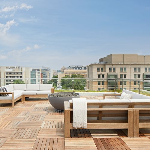 Indulge in outdoor comforts from the rooftop terrace with grills, dining tables, seating, fire pit, and garden enclosure. 