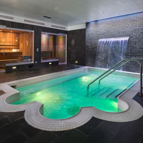 Serene indoor spa featuring indoor pool, steam room, sauna, and private massage room.