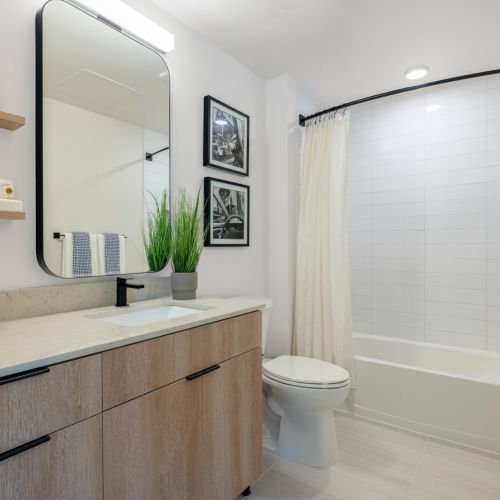 Spacious bathrooms with dual vanities and matte black fixtures.