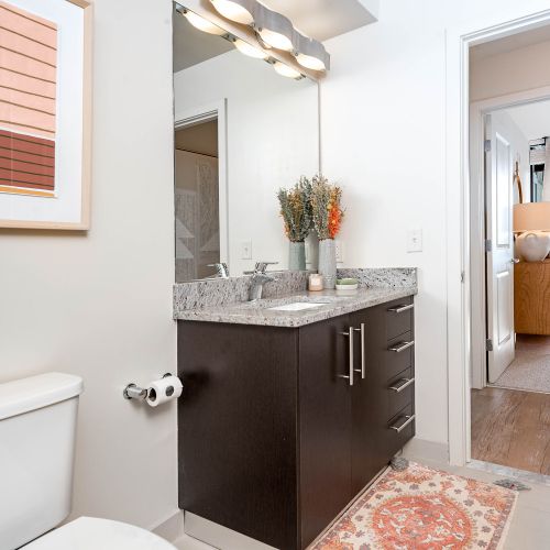 Getting ready is made easier with a vanity that boasts of granite countertops and spacious storage.  