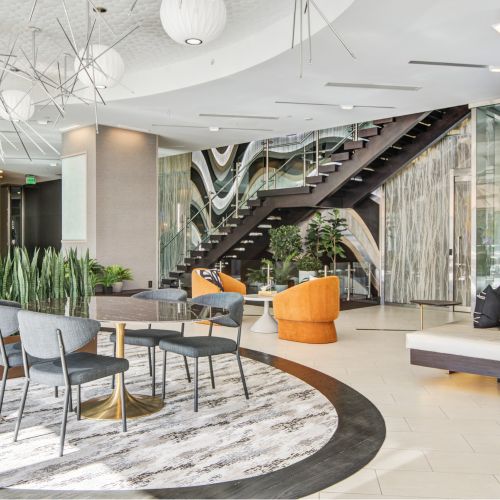 Lobby with lounging areas, grand staircase and mixed media art wall
