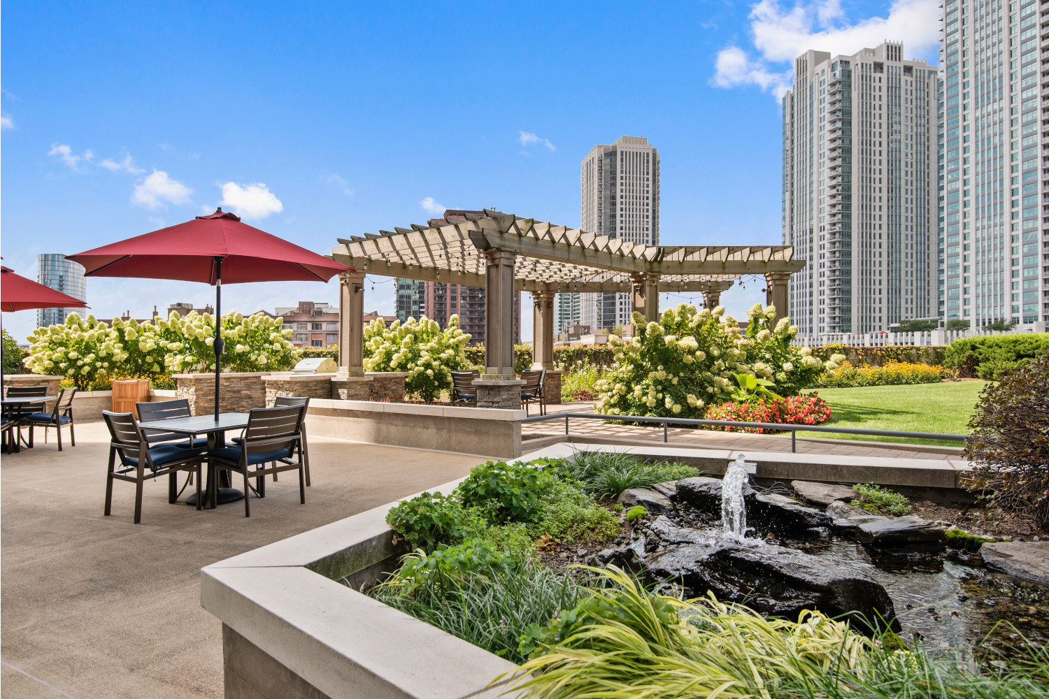 Left Bank : Spacious, landscaped outdoor terrace with lush seating, grills and a fire pit