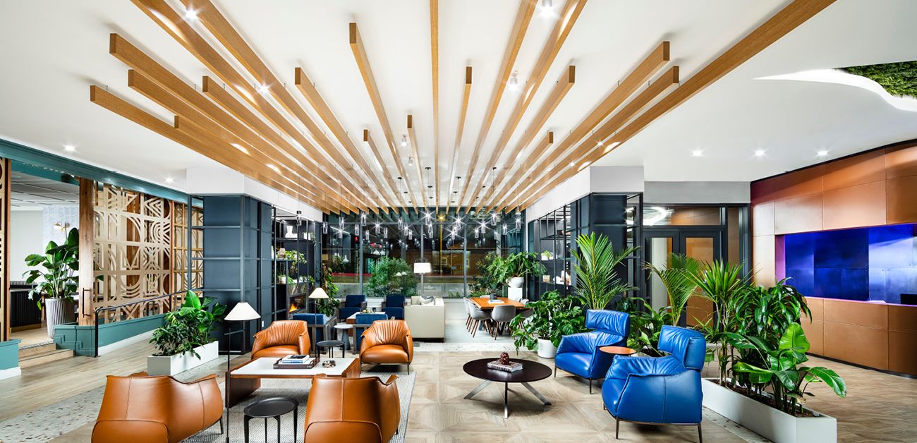 Grand lobby of a Bozzuto apartment featuring a stunning wooden ceiling and luxurious furnishings.