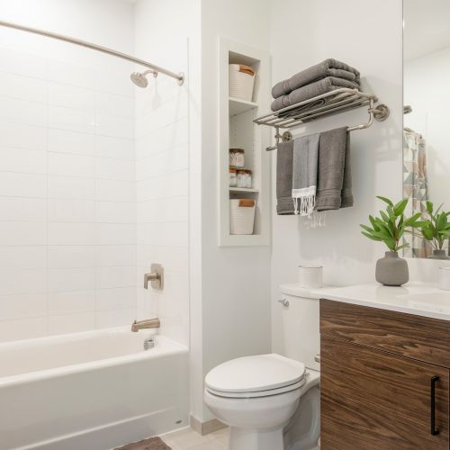 Spacious bathrooms with shower/tubs and built-in wall storage.