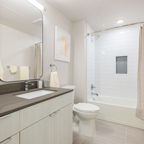 Sleek bathrooms with tiled showers, robe hooks and ample cabinet space