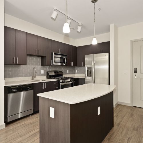 7001 Arlington at Bethesda : Kitchens with stainless steel appliances, ample cabinet storage, and modern tile backsplash