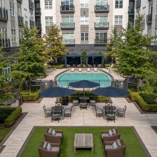 Resort-like grand courtyard with outdoor pool, in-pool chaise lounges and areas for sunning