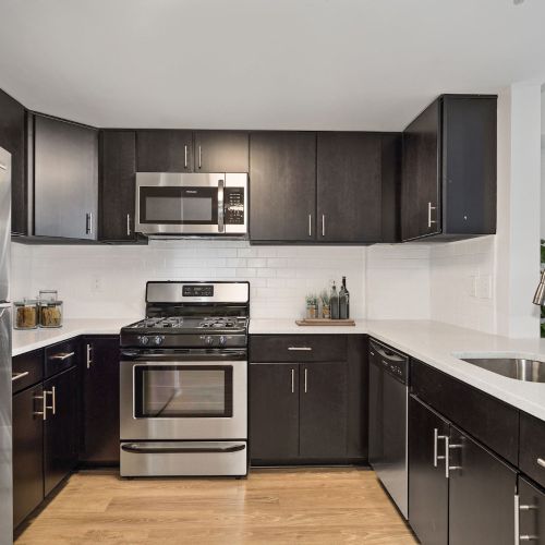 White quartz counters and dark espresso cabinets create an elegant juxtaposition