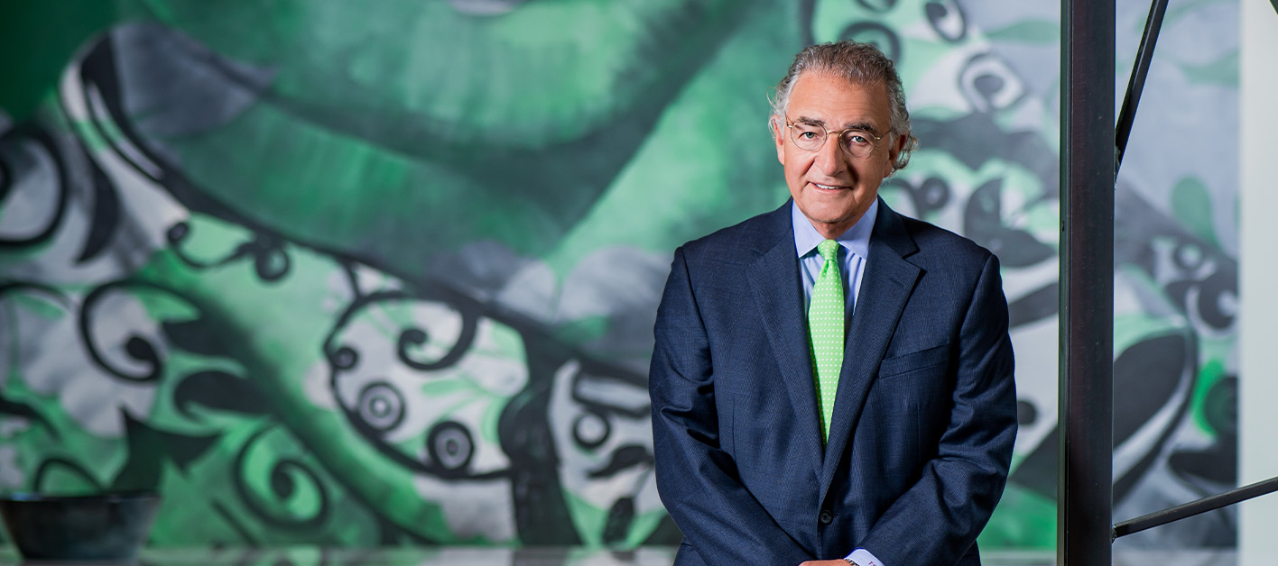 Tom Bozzuto, Bozzuto Group President & CEO, standing in front of a mural.