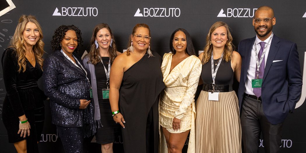 Bozzuto group of people posing on a red carpet at an event.