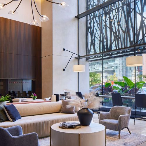 The welcoming lobby features soaring ceilings and a signature art installation.