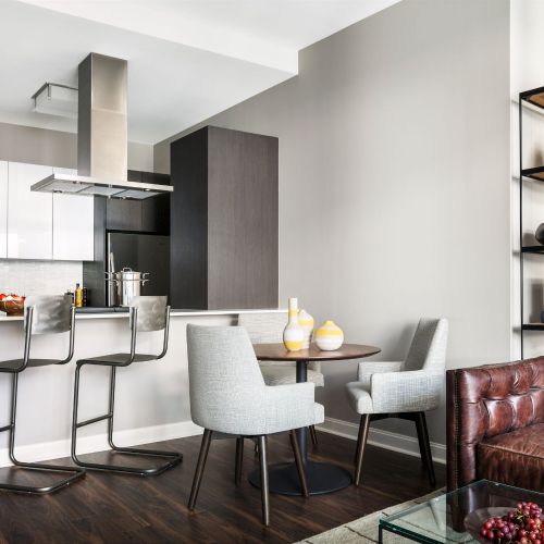 Designer kitchens featuring quartz countertops and a white marble mosaic backsplash.