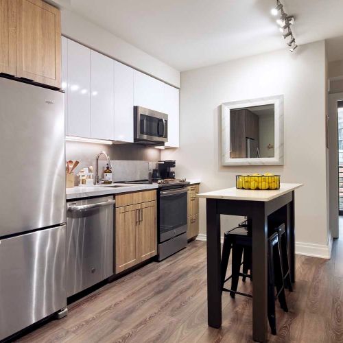 Shared kitchens featuring movable, multi-functional kitchen islands