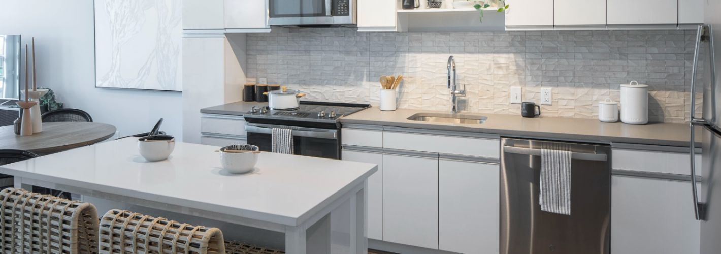 Kitchen with dining island and view of living room	