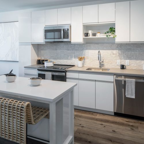 Kitchen with dining island and view of living room	