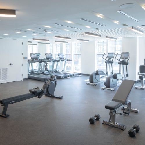 fitness center showing benches and cardio machines	