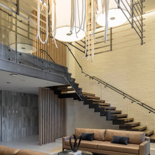 Lobby featuring stairway and beautiful chandelier 	