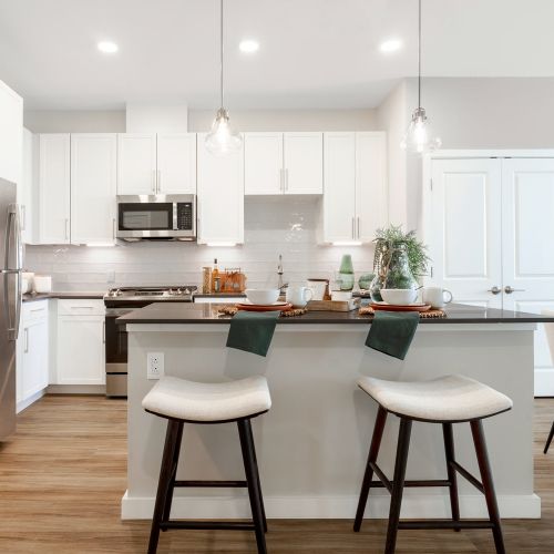 Quartz countertops and large islands with pendant lighting