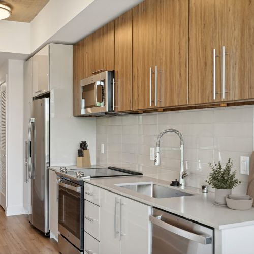 Stainless steel appliances, quartz countertops, and subway tile backsplashes