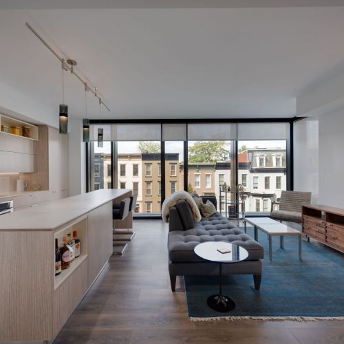 Wood-like flooring throughout the living room, kitchen and bedroom