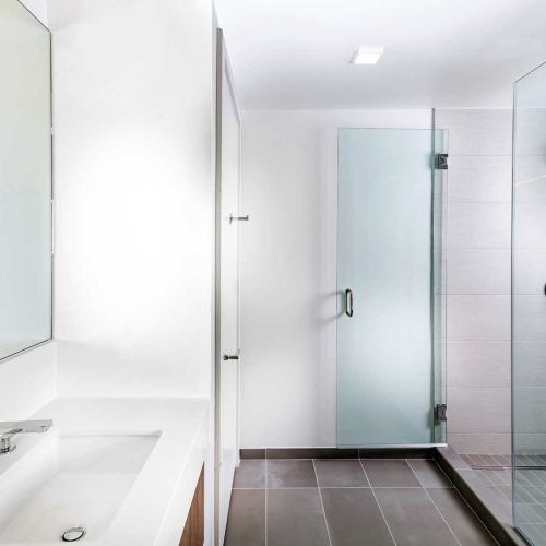 Quartz-topped vanities, floor-to-ceiling bathroom tile and select glass enclosed showers available