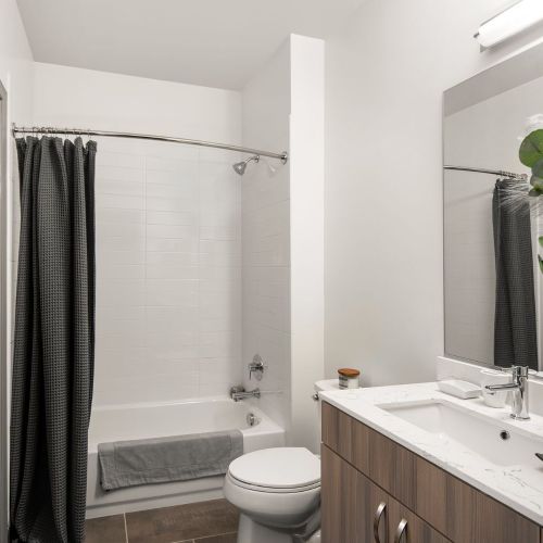 Spacious hotel-inspired bathrooms with quartz vanities