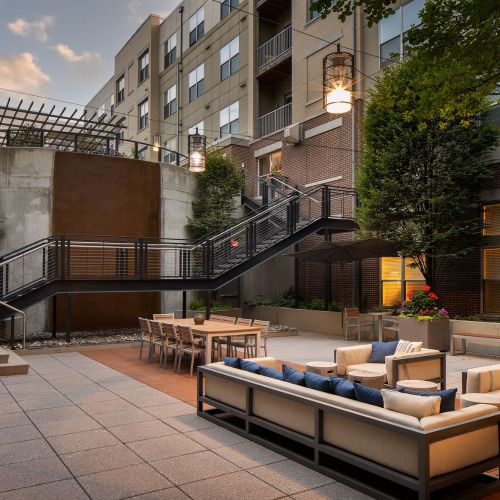 An outdoor, two-tier tranquil courtyard featuring a cascading waterfall