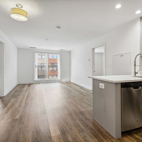 Vacant living room shot with kitchen in view