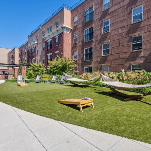 Lawn hammock with cornhole games